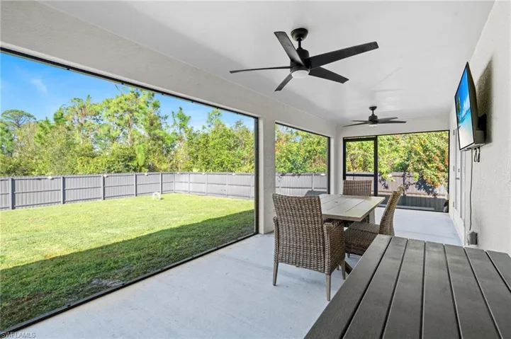 Sunroom / solarium featuring ceiling fan
