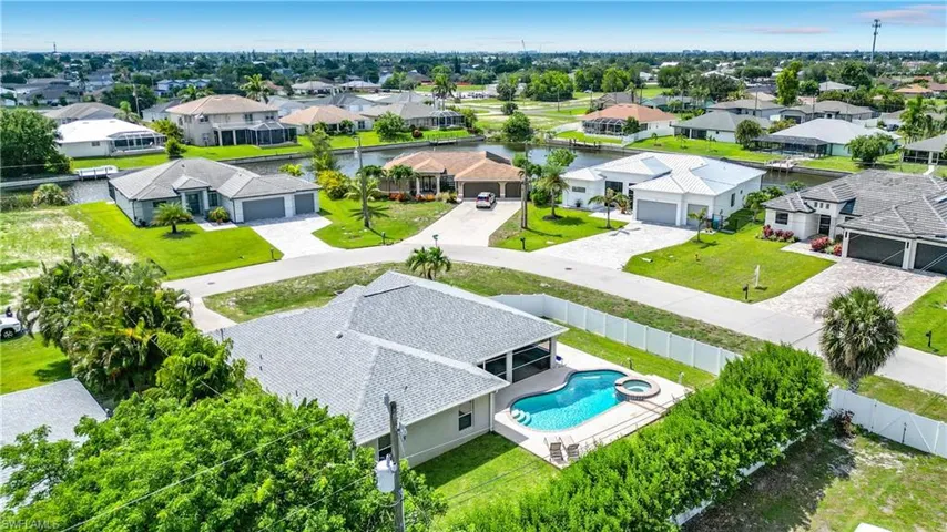 Aerial property view featuring a private swimming pool with integrated spa