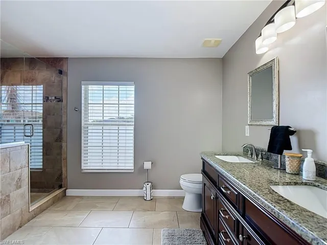 Large master bathroom with walk in closet and dual sinks