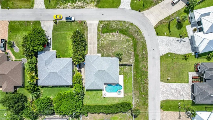Residential property featuring a shingle roof and a private swimming pool