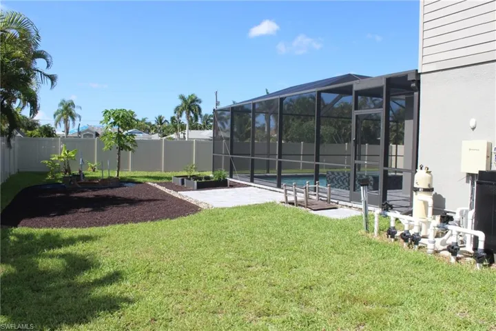 View of yard with glass enclosure and a fenced in pool