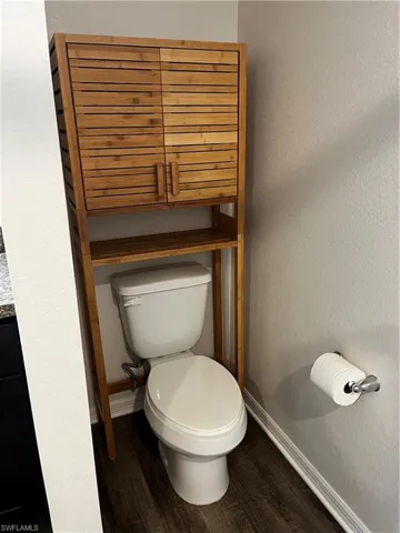 Bathroom featuring hardwood / wood-style flooring and toilet