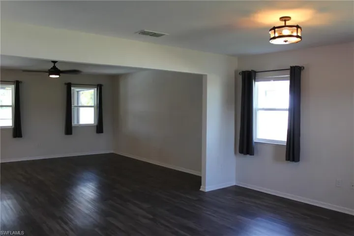 Spare room featuring vinyl style flooring and ceiling fan