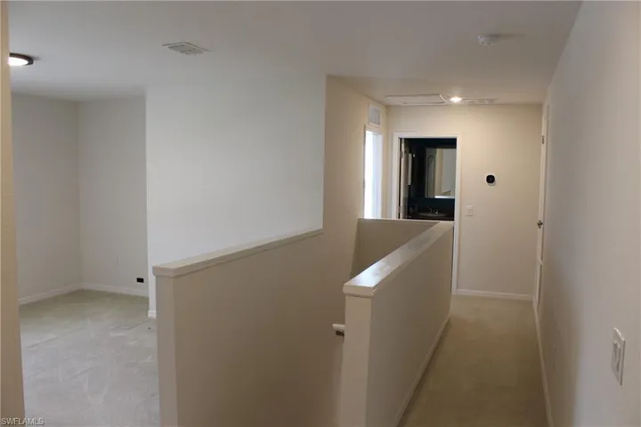 Hallway with light carpet