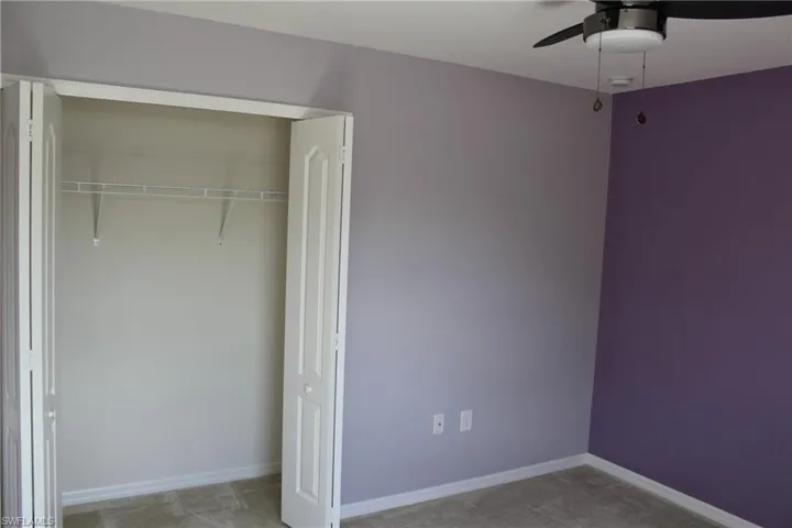 Unfurnished bedroom featuring a closet and ceiling fan
