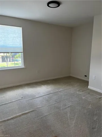 Unfurnished room featuring carpet floors