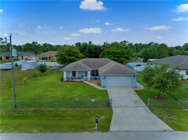 Ranch-style house with a front lawn and a garage
