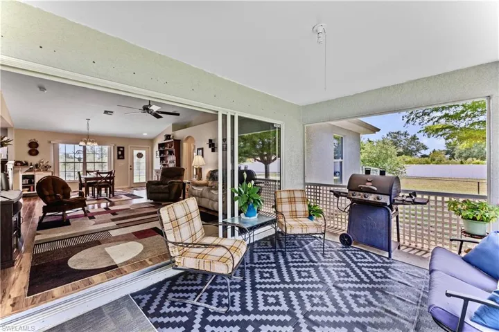 Sunroom / solarium with ceiling fan with notable chandelier