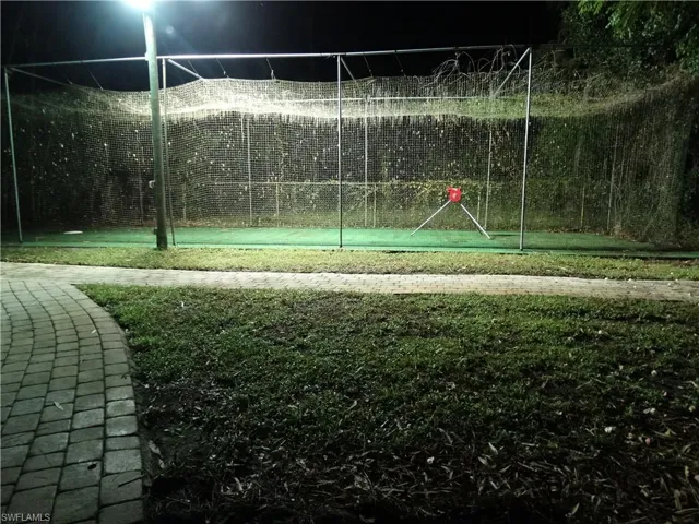 Sport Court for Pickleball, Batting Practice or Basketball Under Netting and Evening Stadium Lighting