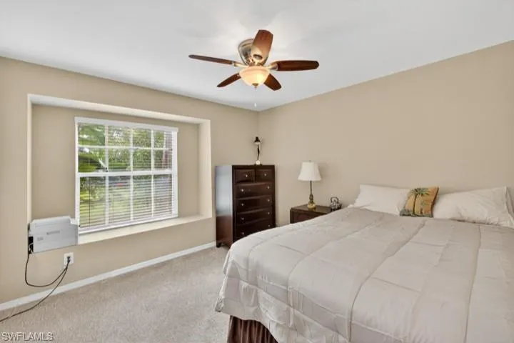 Guest Bedroom 2 featuring newer carpet floors and ceiling fan