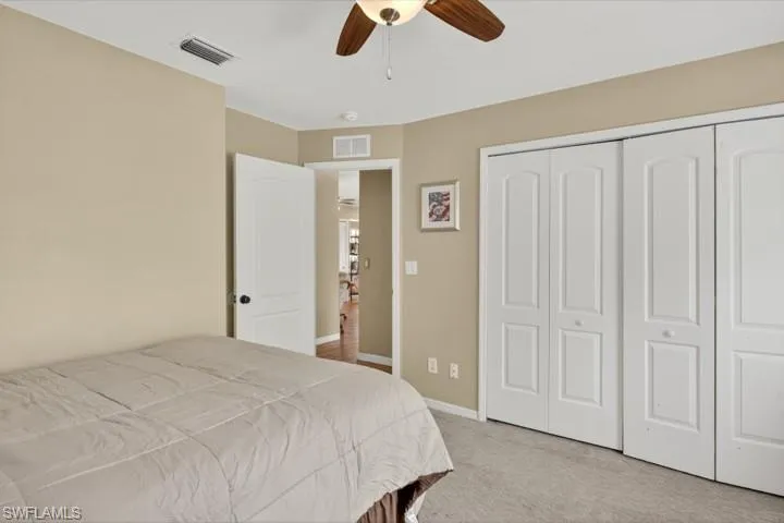 Guest Bedroom 2 with carpet, a large closet, and ceiling fan