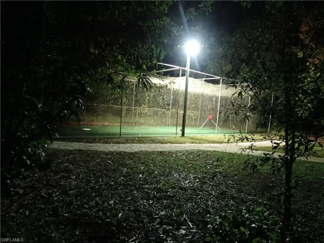 Sport Court for Pickleball, Batting Practice or Basketball Under Netting and Evening Stadium Lighting