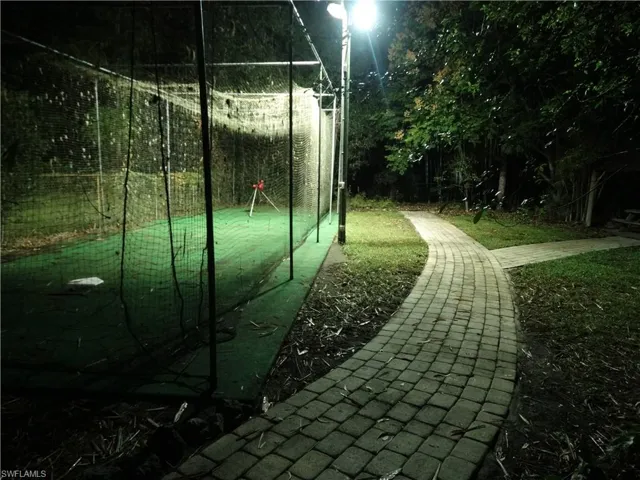 Sport Court for Pickleball, Batting Practice or Basketball Under Netting and Evening Stadium Lighting