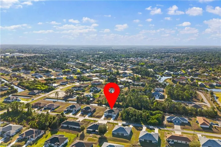 Aerial view of property's location with nearby suburban area