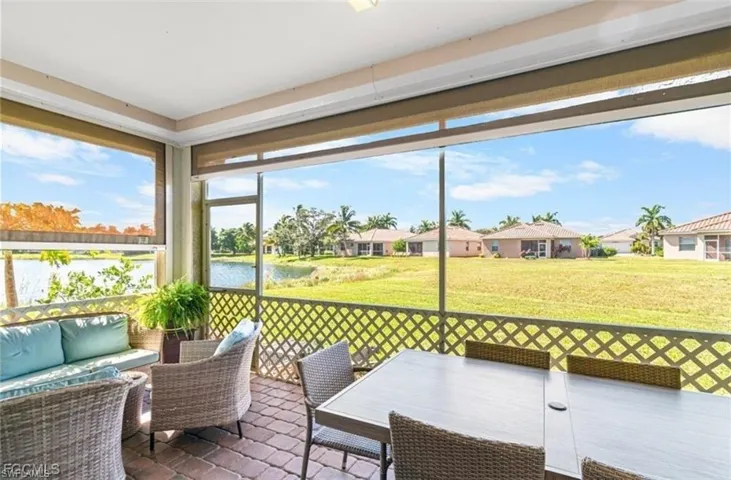 Sunroom featuring an outdoor living / dining area and a water view