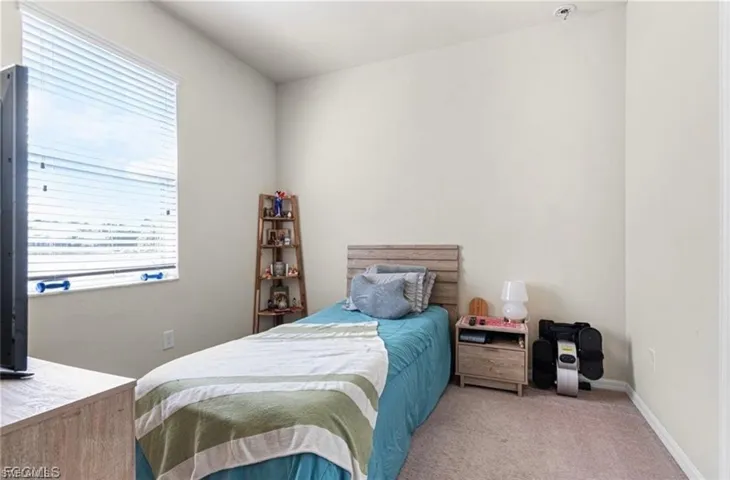 Carpeted bedroom with baseboards