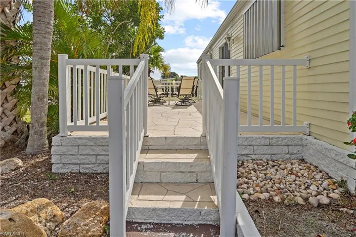 Wooden deck with outdoor dining area and a patio