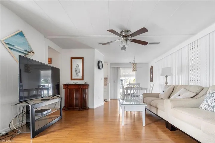 Living room featuring light wood finished floors and ceiling fan