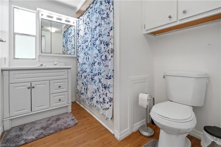 Bathroom featuring vanity, light wood-style floors, and ornamental molding