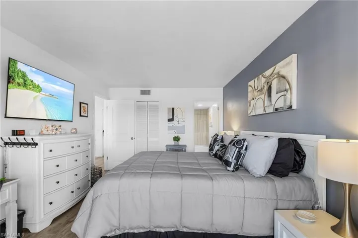 Bedroom featuring wood finished floors and visible vents
