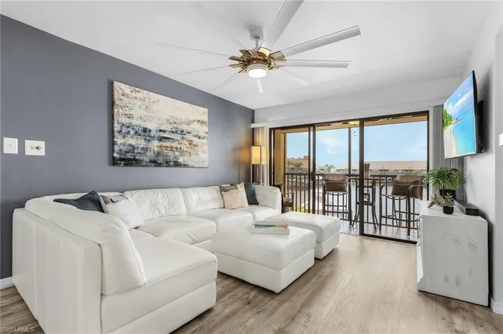 Living area featuring a ceiling fan and wood finished floors