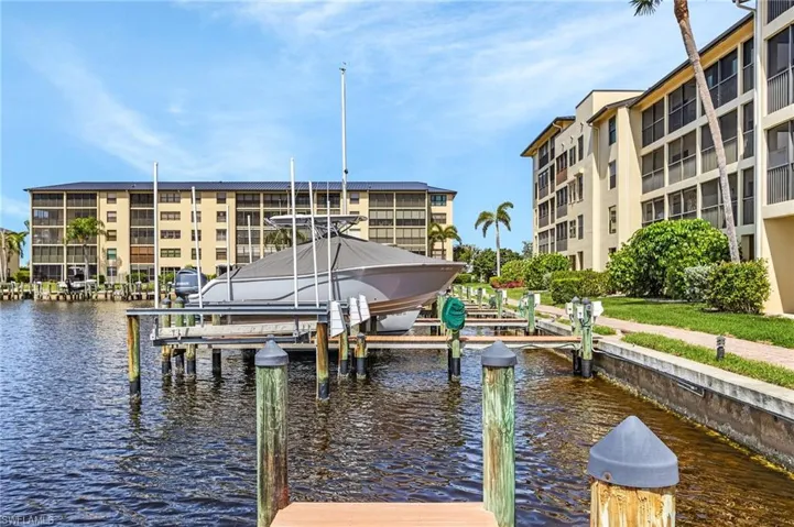 View of dock with boat lift and a water view