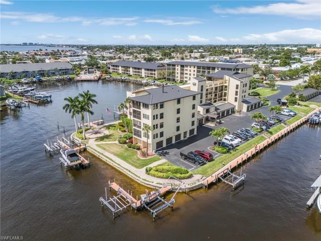Birds eye view of property with a water view
