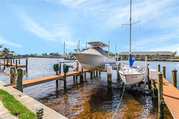 Dock area with a water view and boat lift