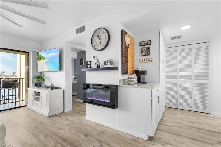 Kitchen featuring white cabinetry, visible vents, and light wood-type flooring