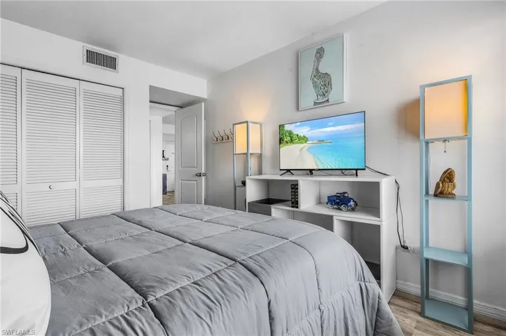 Bedroom featuring baseboards, a closet, visible vents, and light wood-type flooring