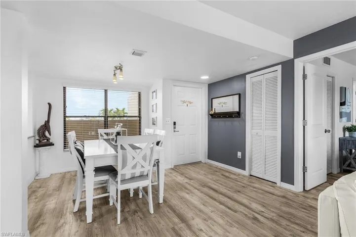 Dining space with baseboards, light wood-style flooring, and visible vents