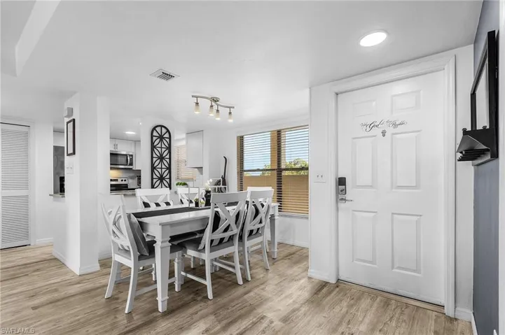 Dining room with light wood finished floors, baseboards, visible vents, and recessed lighting