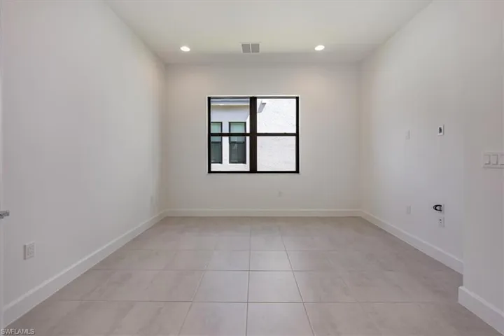 Unfurnished room with light tile patterned flooring