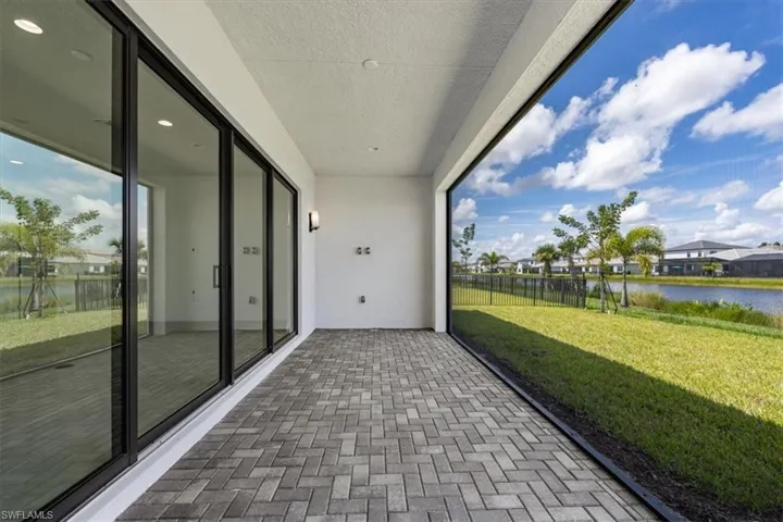 Unfurnished sunroom featuring a water view