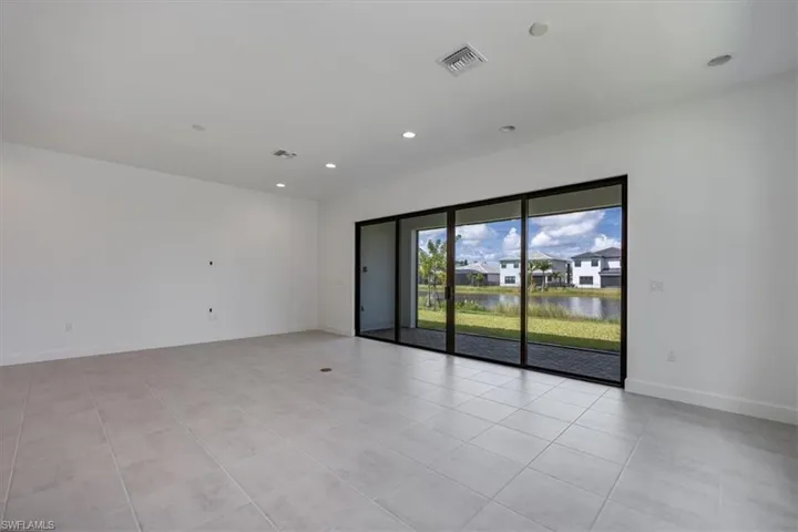 Tiled spare room featuring a water view