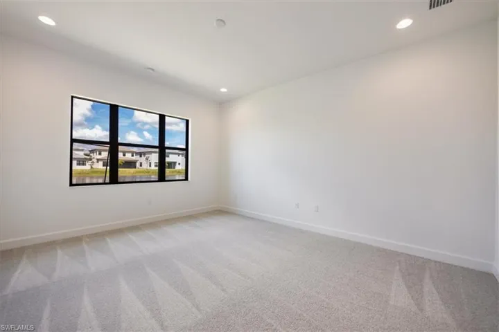 Unfurnished room featuring light colored carpet