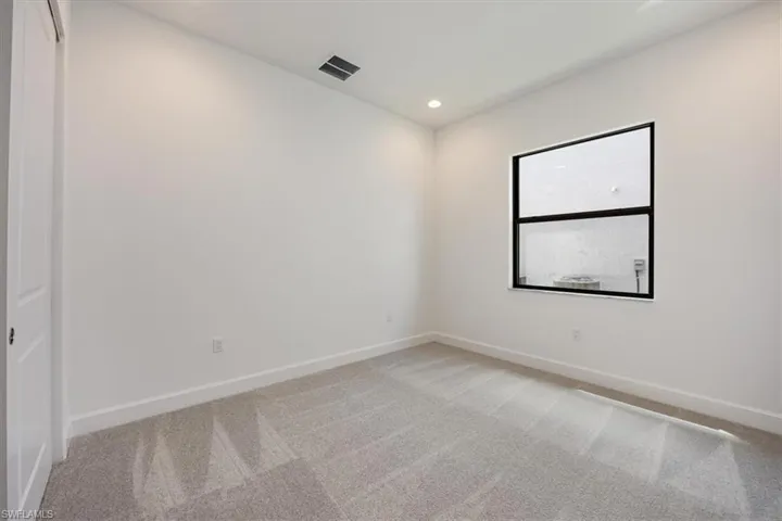 Unfurnished room featuring light colored carpet