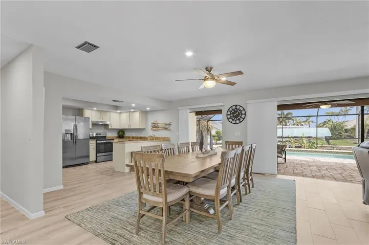 Formal Dining, new dining furniture!! OPEN Split Floor Plan, new ceiling fan, view of pool and canal.  Enter lanai - 2 sets of pocketing sliding doors to lanai.