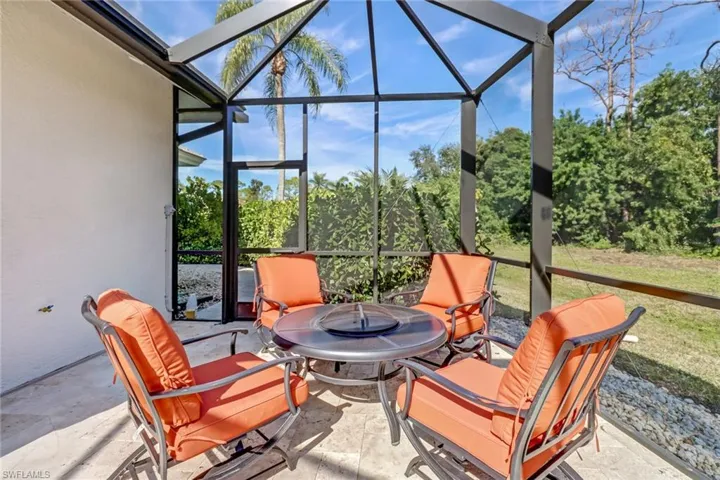 Sunroom with a patio area and a fire pit