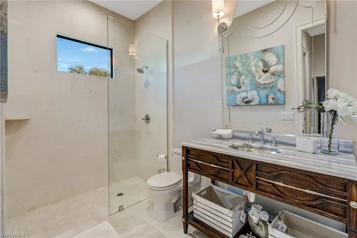 Full bathroom with vanity, a walk in shower, and light tile patterned floors