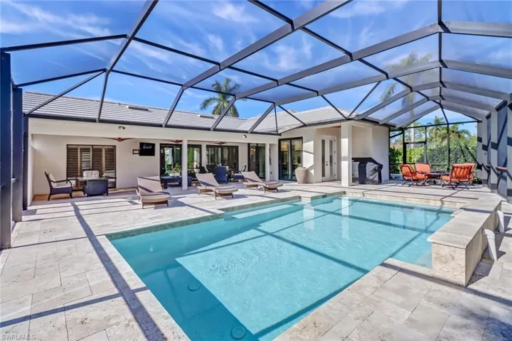 Outdoor pool featuring a sunroom, a patio area, ceiling fan, and outdoor lounge area