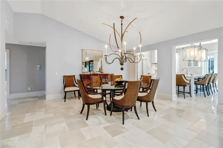 Dining area with vaulted ceiling and a chandelier