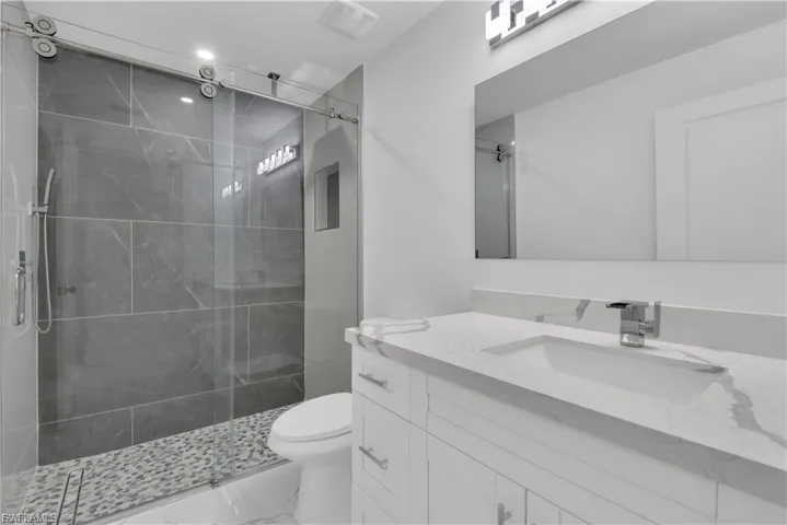 Bathroom with vanity and a stall shower