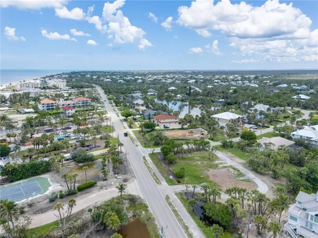 Aerial overview of property's location with a nearby body of water and nearby suburban area