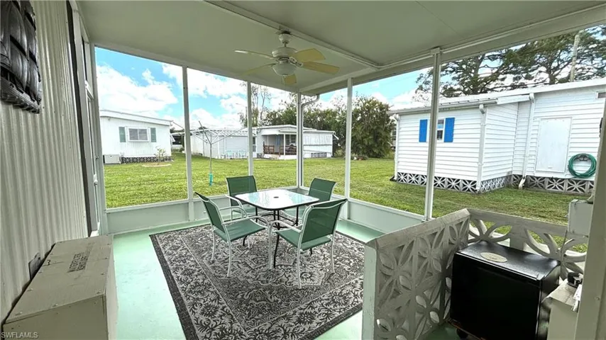 Spacious screened rear patio with ceiling fan & mini-fridge.