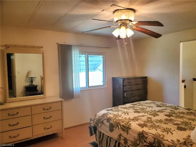 Primary Bedroom ceiling fan and laminate floors.