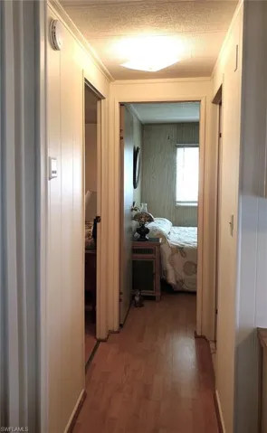 Primary suite to the left; Guest bedroom straight ahead; Hall bath to the right.