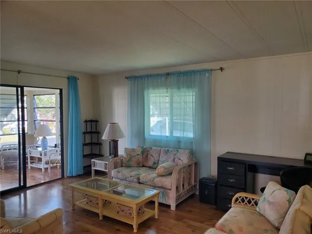 Spacious Living Room has lustrous wood laminate flooring and lots of light!