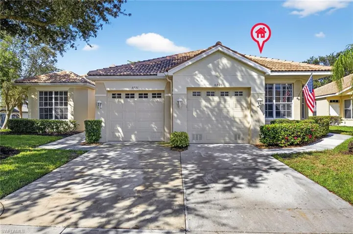 View of front of home with a tiled roof, stucco siding, concrete driveway, and a garage