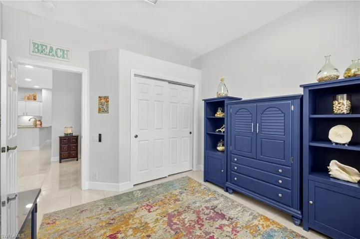 Bedroom with light tile patterned floors and a closet